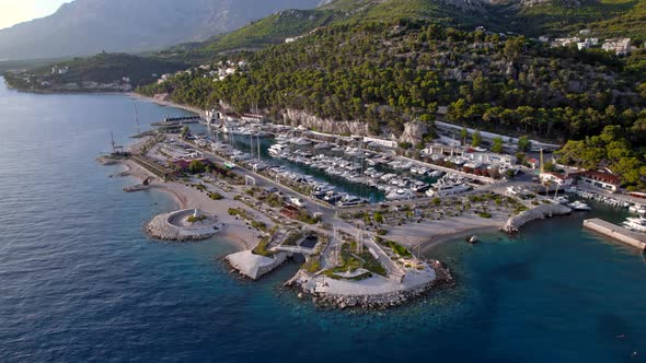 Drone  Aerial of the Marina with Yachts in the Bay Near the Mountains in Sunset Light