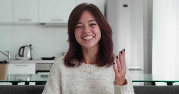 Authentic Shot of Happy Brunette Woman is Making Video Technology Call to Friends or Family with