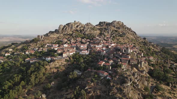 Scenic mountaintop village of Monsanto, Portugal; panning aerial view