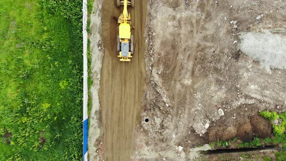 The process of building roads. The tractor aligns the ground.