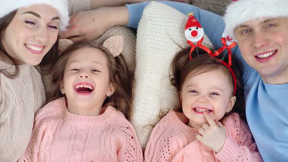 Closeup Face of Smiling Festivity Parent Hugging Funny Children Pose Togetherness Looking at Camera