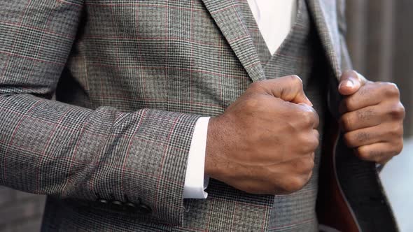 Closeup of a Elegant African Businessman in Brown Jacket and Coat Near Office Center