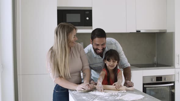 Joyful Family Couple and Little Kid Applying Flour on Faces