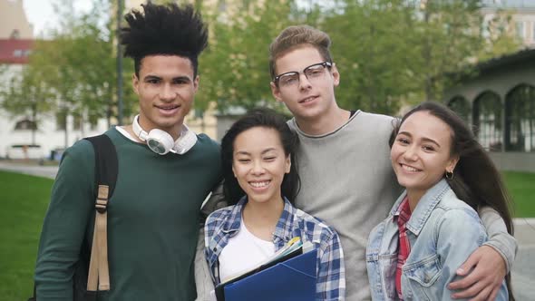 Very Nice and Friendly Mixed-race Students Are Standing Together Near College