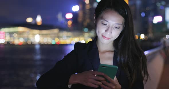 Business woman use of smart phone at night 