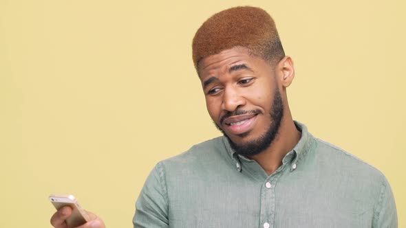 Portrait of Metis Joyful Guy with Stylish Haircut Reading Funny News Good Information on Mobile