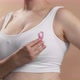 Caucasian Woman in a White Seamless Bra Put Pink Ribbon for Breast Cancer - VideoHive Item for Sale