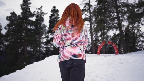 Happy Girl in Skiing Equipment Runs and Smiles of Snowy Mountains and Forest