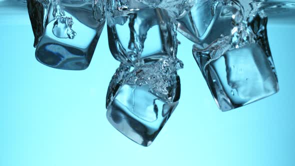 Super Slow Motion Shot of Clear Ice Cubes Falling Into Water at 1000Fps