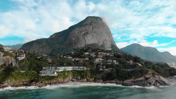 Aerial approach of the beautiful picturesque cliff rocks of Joatinga beach in Rio de Janeiro with th