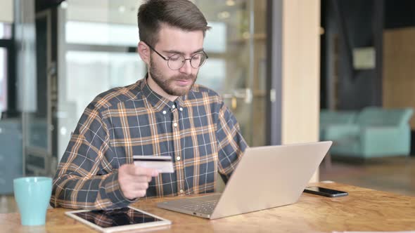 Young Designer Get Failure of Using Credit Card on Laptop