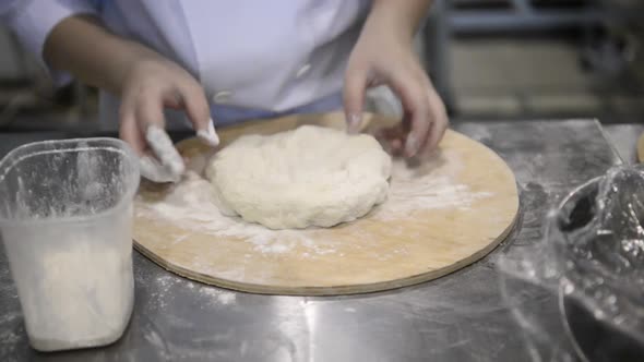 Cook's Hands Knead the Dough