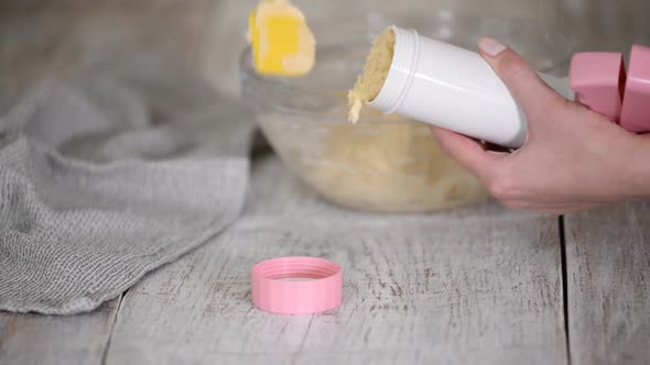 Closeup of a Home Baker Putting Dough Into Cookie Press