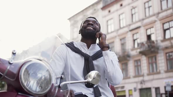 African American Man with Pleasant Smile Talking on Phone