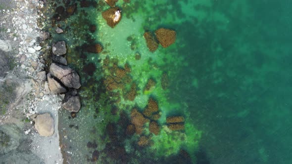 Aerial View on Calm Azure Sea and Volcanic Rocky Shores