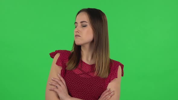 Portrait of Tender Girl in Red Dress Is Very Offended Then Smiling. Green Screen