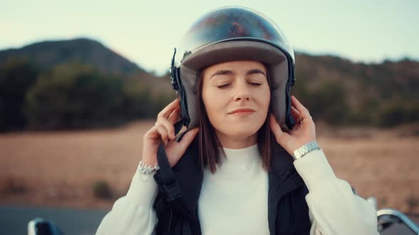 Young Woman Wears Open Face Helmet Before Riding A Motorbike. - close up