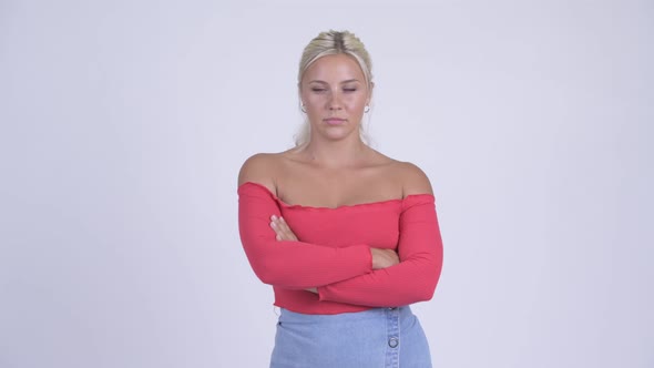 Young Angry Blonde Woman with Arms Crossed