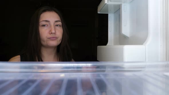 Woman Opens Refrigerator and Takes Chocolate Breaking Diet