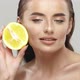 Gorgeous Woman Holding Orange and Stroking Her Face - VideoHive Item for Sale