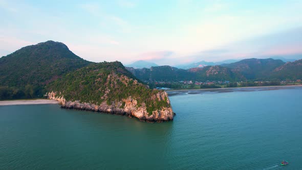 4K aerial view of mountain coast near beautiful beach and sea. Flight over sea.