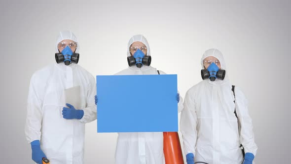 Group of Epidemiologists in Protective Uniform Holding Blank Placard on Gradient Background