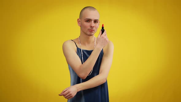 Portrait of Young Caucasian Man in Dress Posing with Red Lipstick at Yellow Background