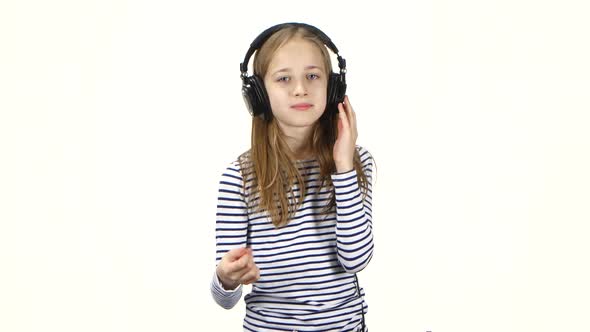 Child Listens Music in Headphones and Snaps Fingers Into Rhythm alt