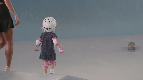 Mother and Child Skateboarding in Indoor Skate Park