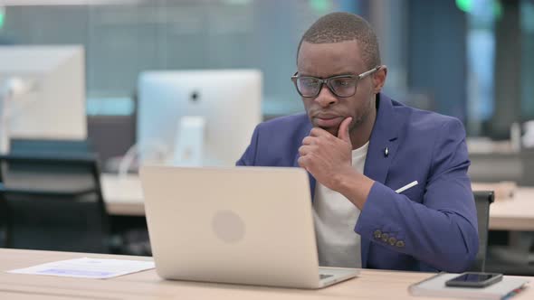 Young African Businessman Working on Laptop in Office