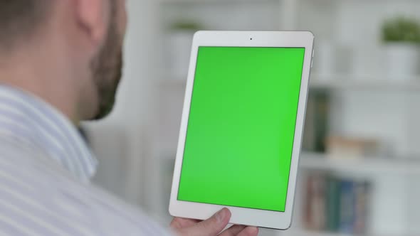 Rear View of Young Man Using Tablet with Chroma Screen 