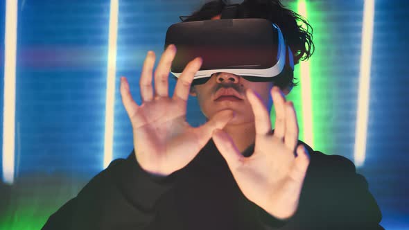 Young Man Using a New Program in Virtual Reality Glasses