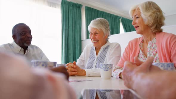 Group of Mixed-race senior friends interacting with each other on dining table 4k