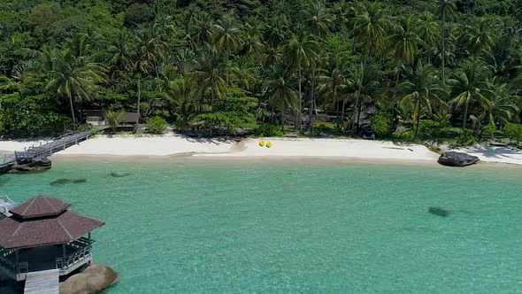 Aerial of a perfect tropical private beach in Asia. CROP TILT