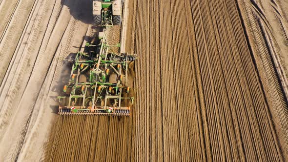 Tractor with Harrows on the Farmland