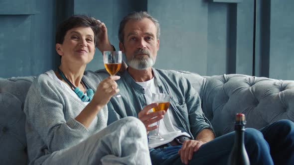 Happy Aged Couple Drinking Wine