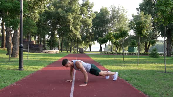 Young Man Sportsman Doing Burpee Exercise in Park Outdoor Burpee