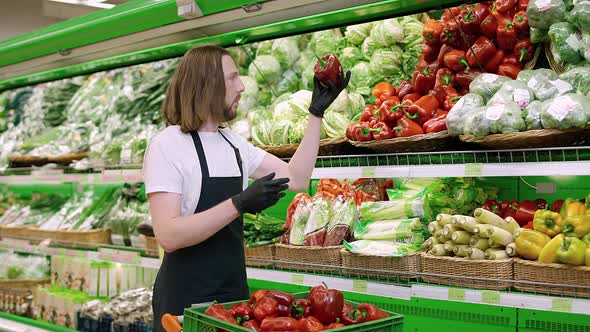 Man Replenishes Products on the Shelves Young Man Puts Paprika on a Shelf in an Organic Store Works