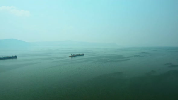 Aerial View, Cargo Barges Sailing Into the Sea. Cargo Ships Sail Across the Endless Sea.