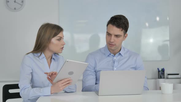 Sharing Opinions, Business Colleagues Using Tablet and Laptop During Work