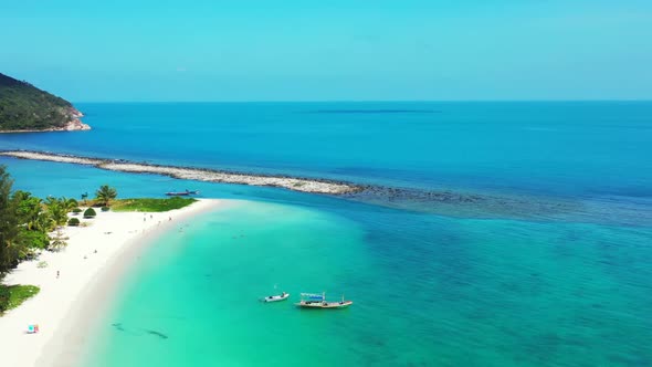 Aerial drone view scenery of tranquil lagoon beach wildlife by aqua blue lagoon with white sand back