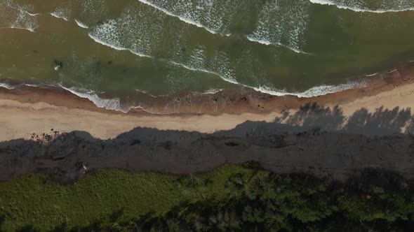 Aerial Flight Up Above Amazing Turquoise Baltic Sea with Waves and Shadow Play