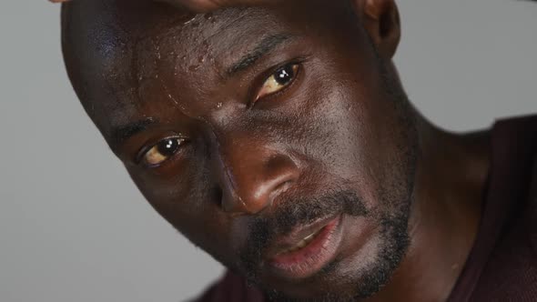 Portrait of sweaty fit african american man exercising inside gym