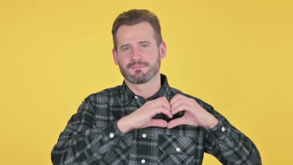 Portrait of Middle Aged Man Showing Heart Shape By Hands