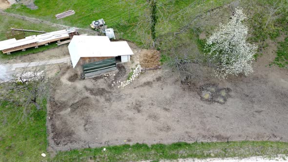 A farm paddock outdoors with a puddle and mud.