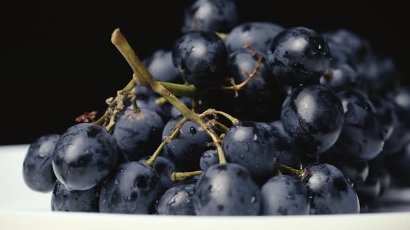 A Bunch of Blue Wet Grapes Spinning Slowly