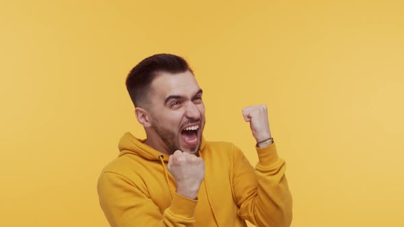 Expressive young man screaming and shouting over vibrant background.