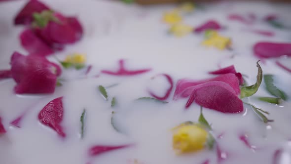 Closeup White Milk Water with Red and Yellow Roses