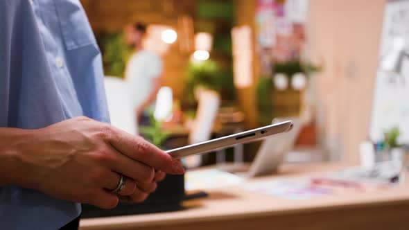 Close Up Hand of Female Content Creator Typing on Tablet