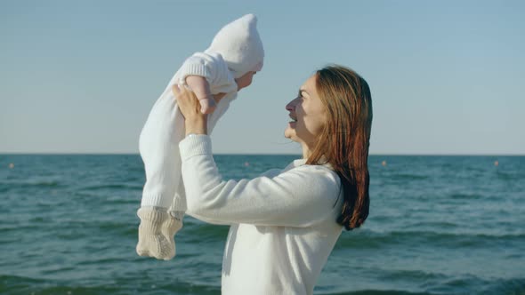 Mom Holds Her Newborn Daughter in Her Arms